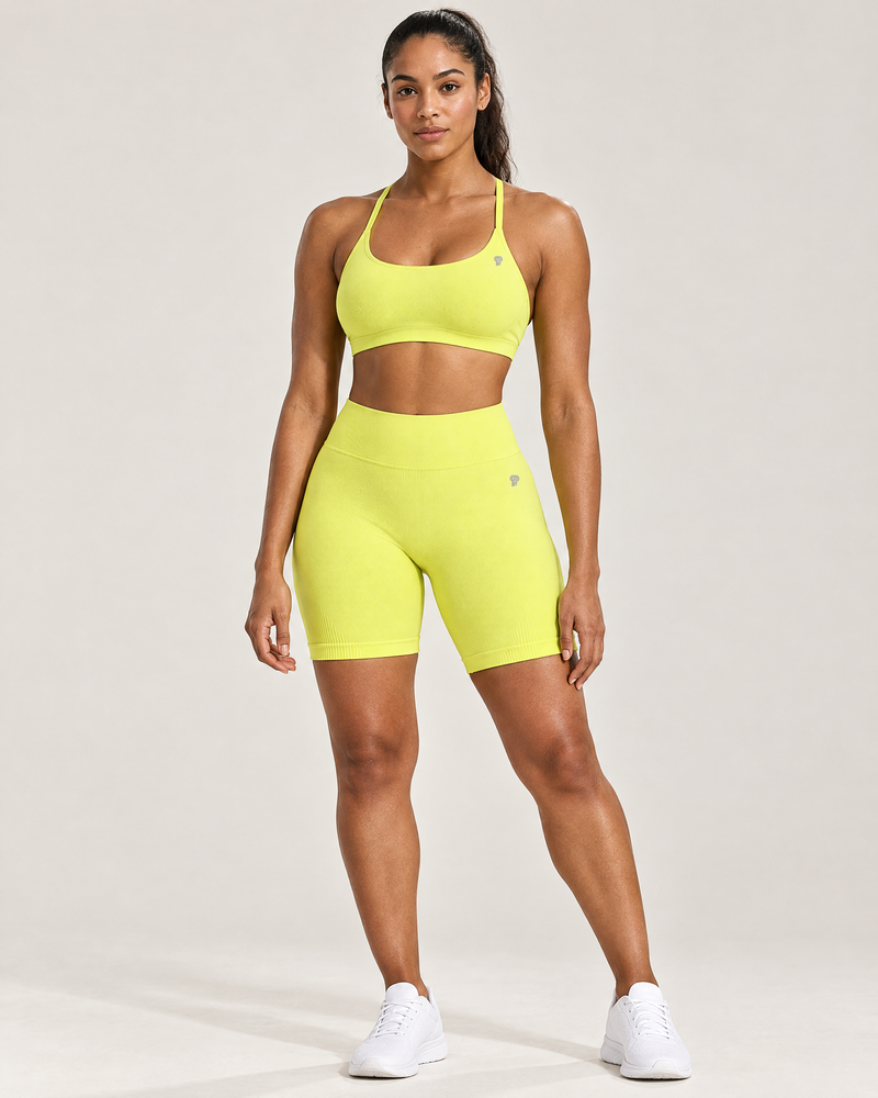 Polocom Plus Lift Seamless Bra & Biker Shorts Set in Bright Yellow, worn by an adult model with a small silver P emblem