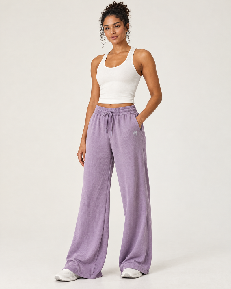 Polocom Plus Ease Waffle Wide-Leg Pants in Taro Purple, worn by an adult model with a small silver P emblem