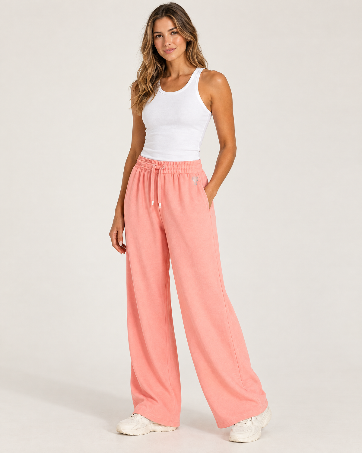 Polocom Plus Drift wide-leg drawstring pants in Sakura Pink, worn by an adult model with the small silver P emblem