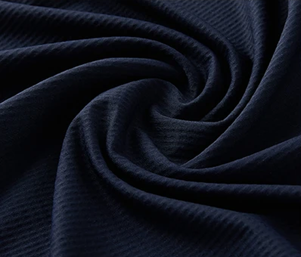 Polocom Plus Edge Stretch Golf Polo in Navy, knit fabric texture detail