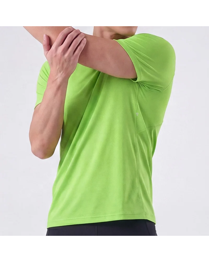 Featherlight Training Tee in Green, model stretch pose
