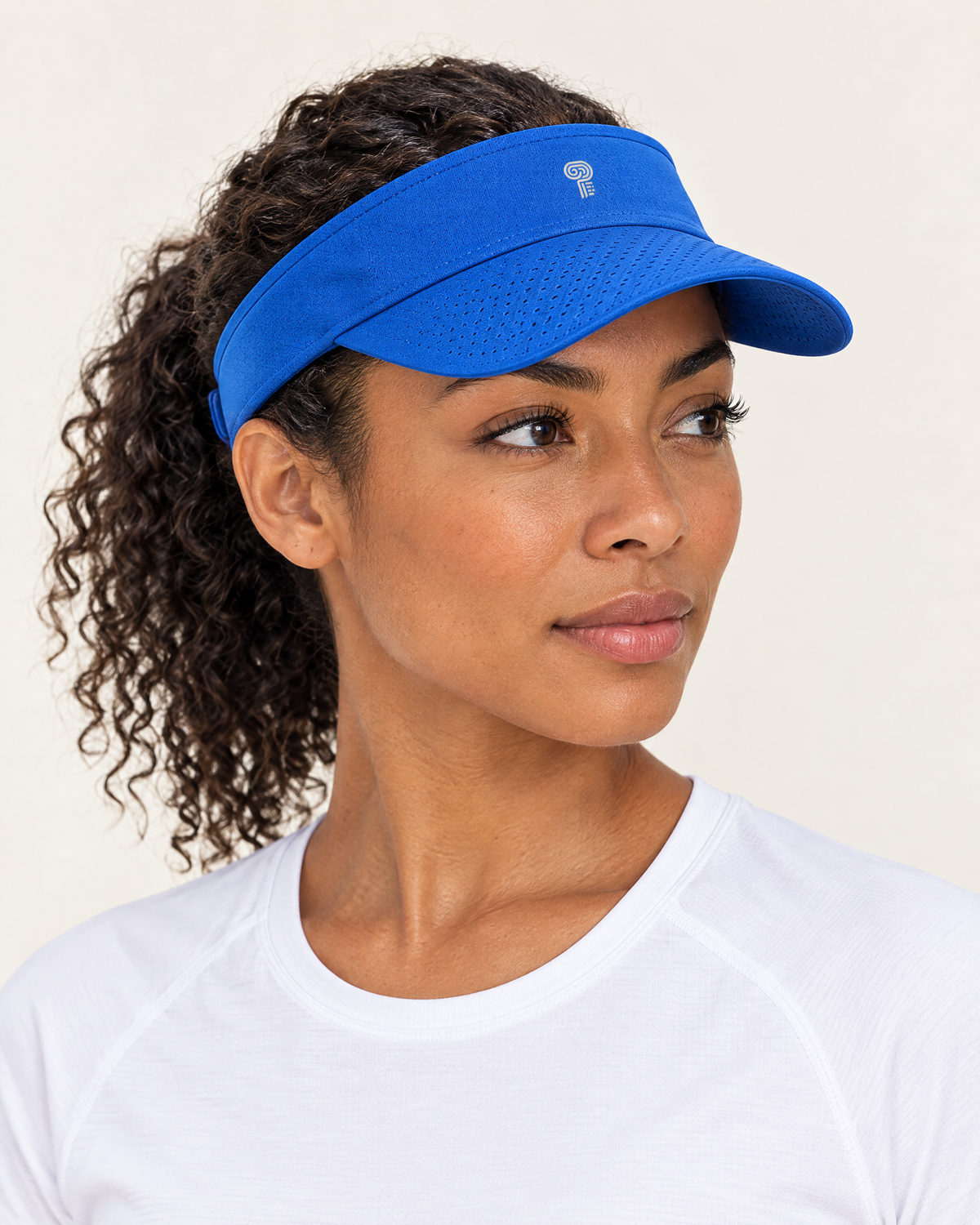 Polocom Plus Court Adjustable Sports Visor in Blue, worn by an adult model with a small silver P emblem