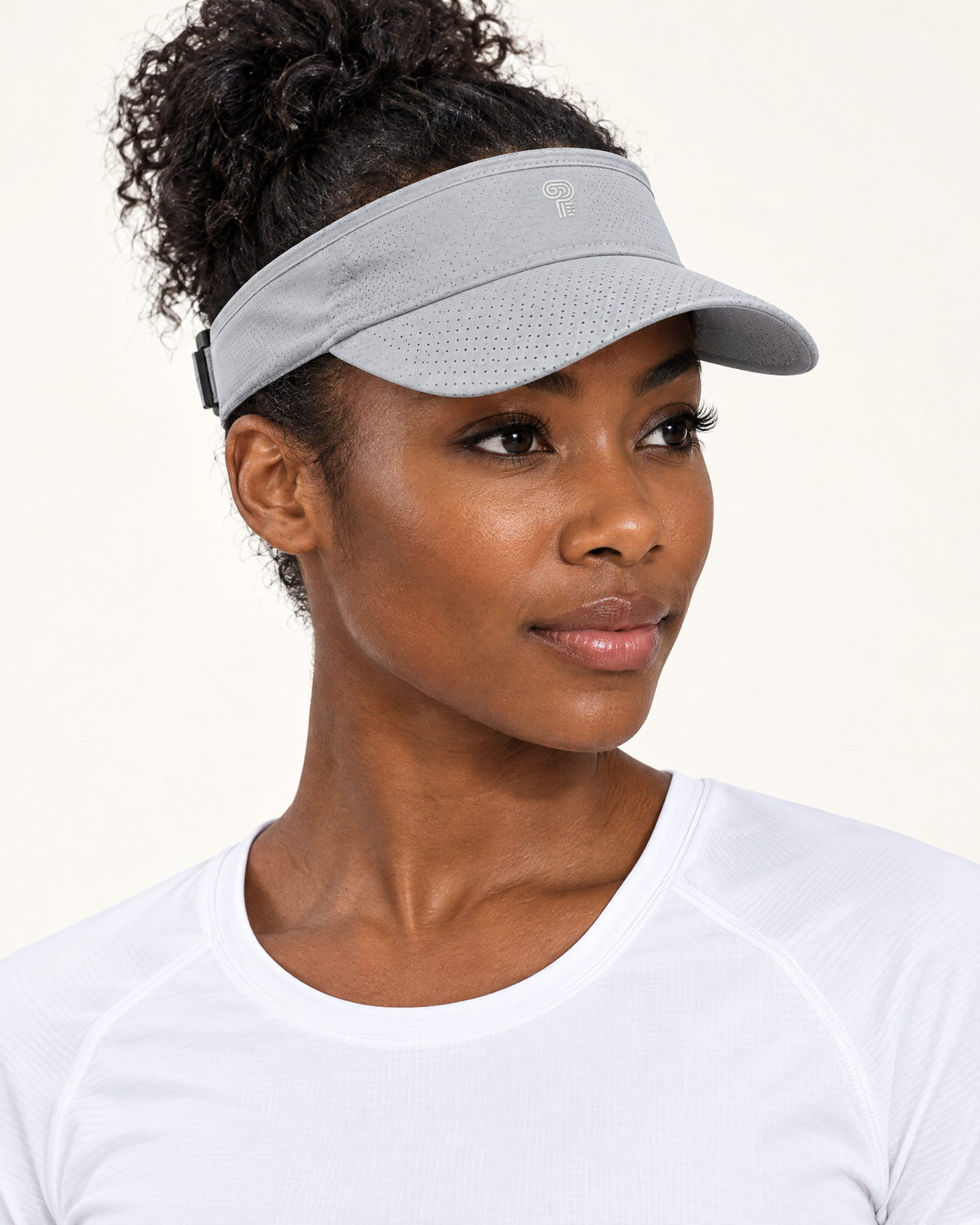 Polocom Plus Court Adjustable Sports Visor in Light Gray, worn by an adult model with a small silver P emblem