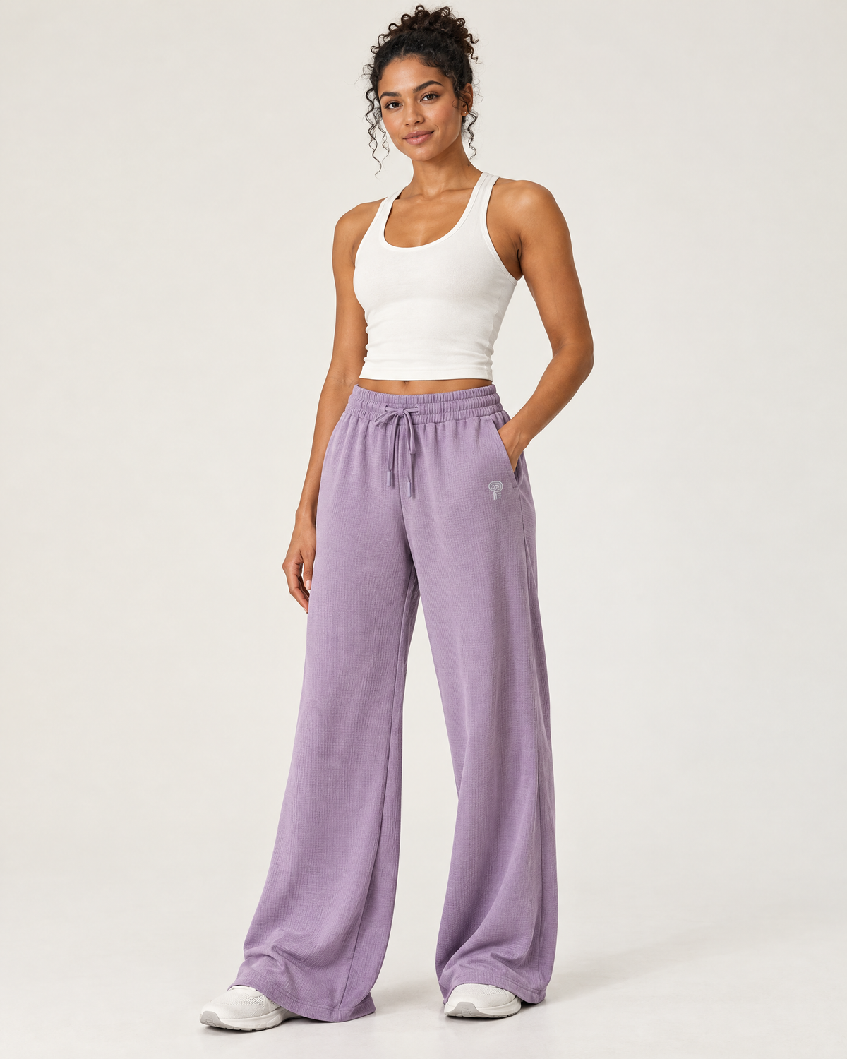 Polocom Plus Ease Waffle Wide-Leg Pants in Taro Purple, worn by an adult model with a small silver P emblem