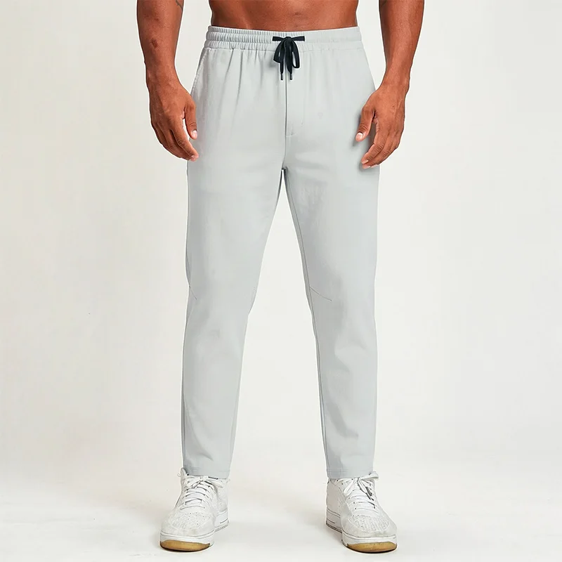 Polocom Plus Flow Drawstring Pants in White Grey, front view worn by an adult male model