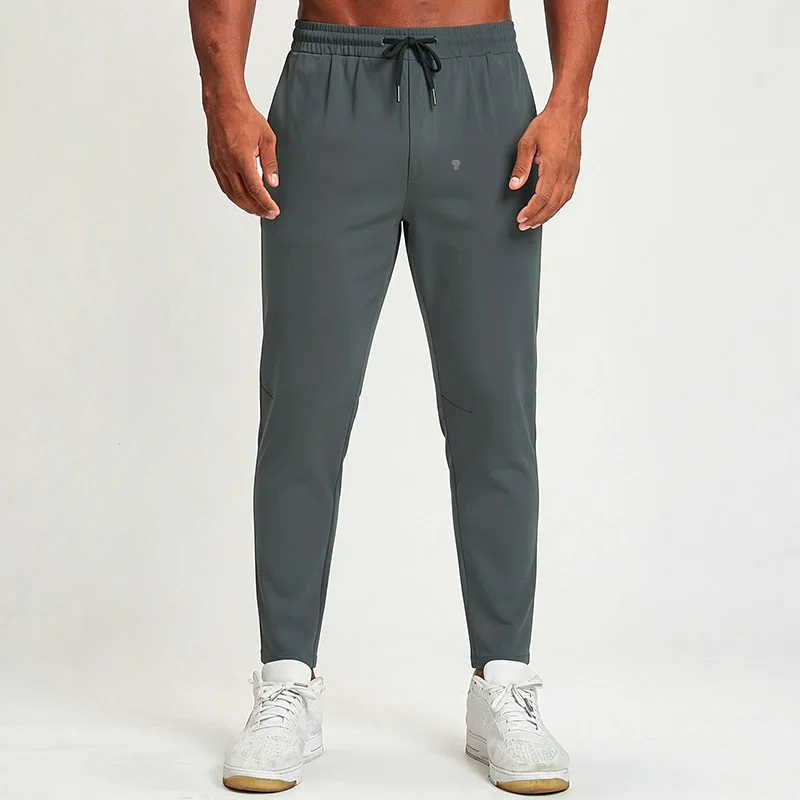 Polocom Plus Flow Drawstring Pants in Dark Grey, front view worn by an adult male model