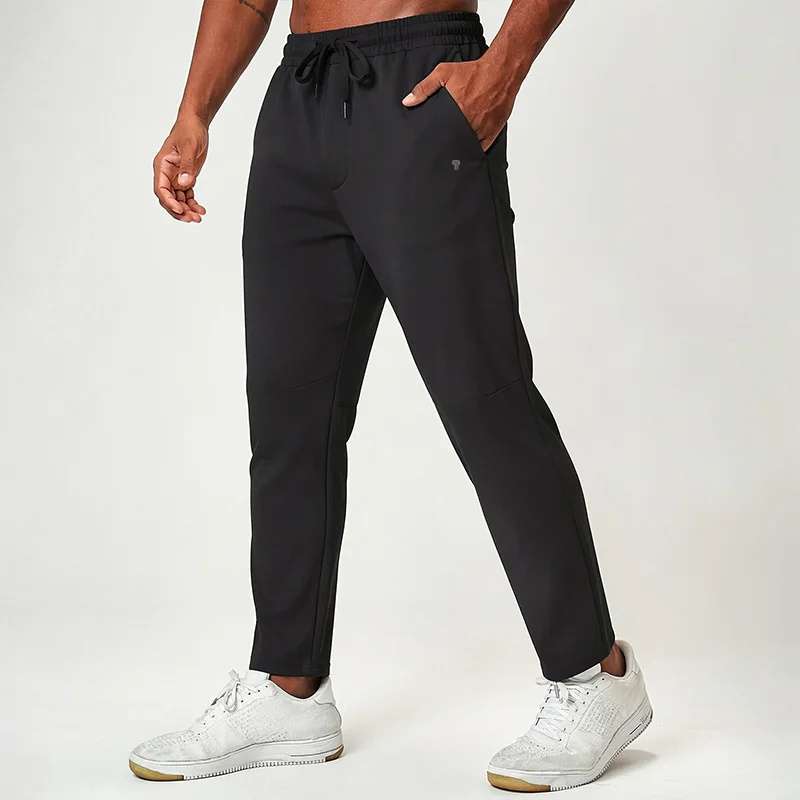 Polocom Plus Flow Drawstring Pants in Black, front view worn by an adult male model