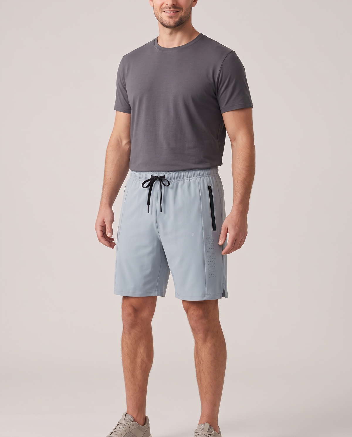 Pace light gray training shorts on model, wearer-left zip pocket and ventilation panel