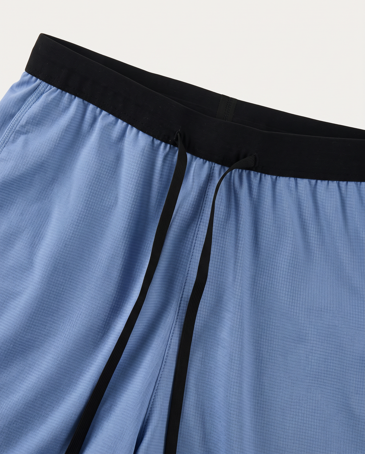 Velocity blue running shorts, black waistband and drawcord detail
