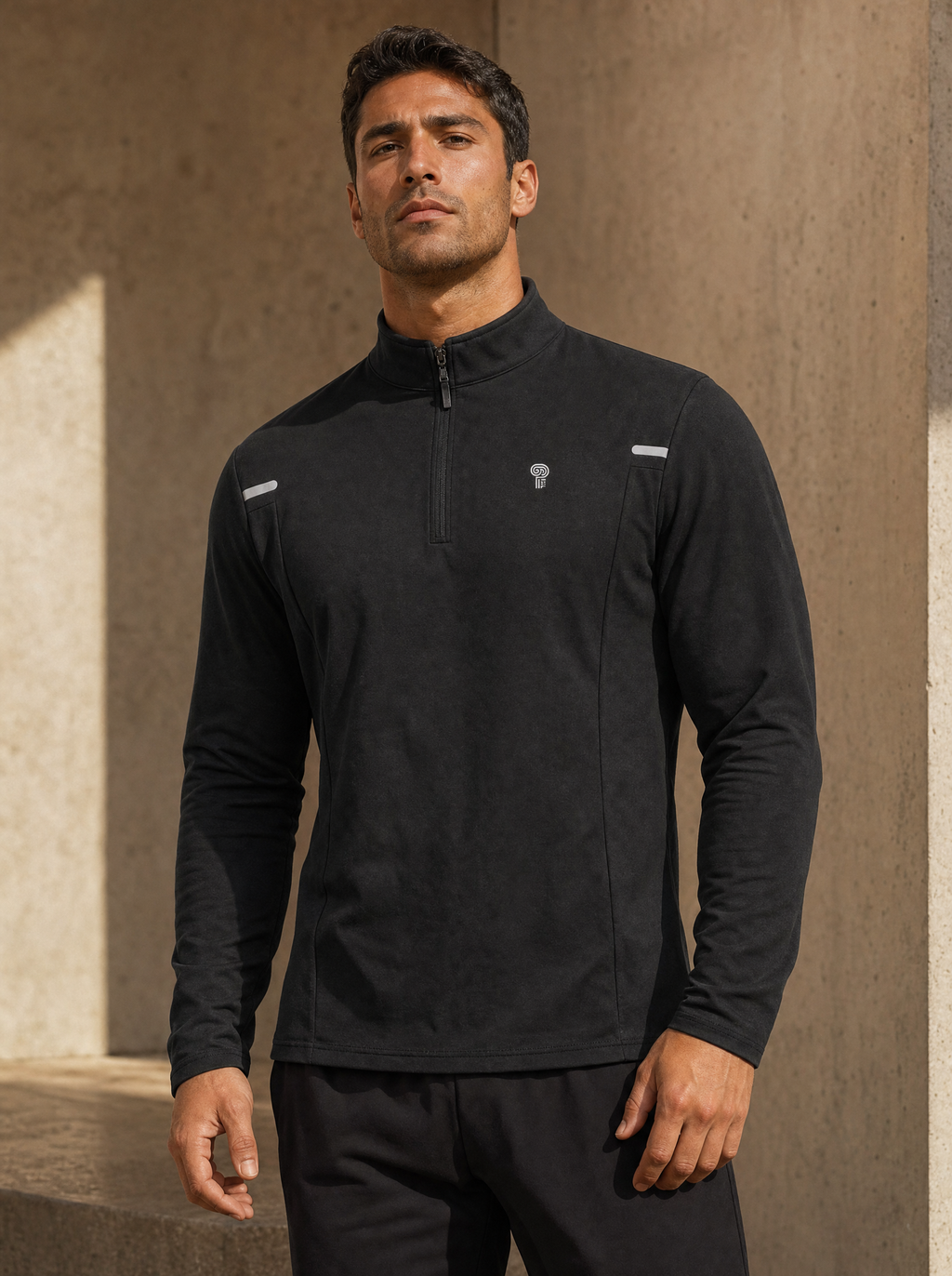 Polocom Plus black quarter-zip with reflective shoulder details worn by an adult man.