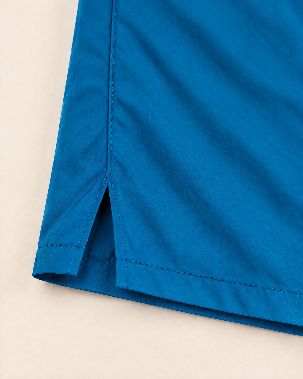 Polocom Plus Stride Side-Split Running Shorts | Peacock Blue | Hem detail view
