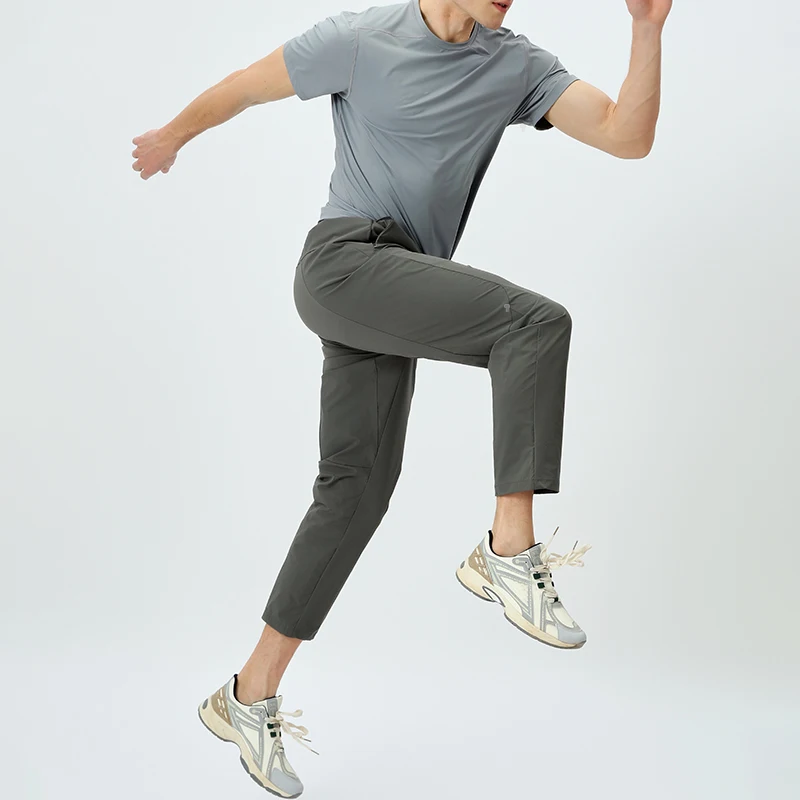 Polocom Plus Tempo Tee & Training Pants Set in Gray, adult male model in motion